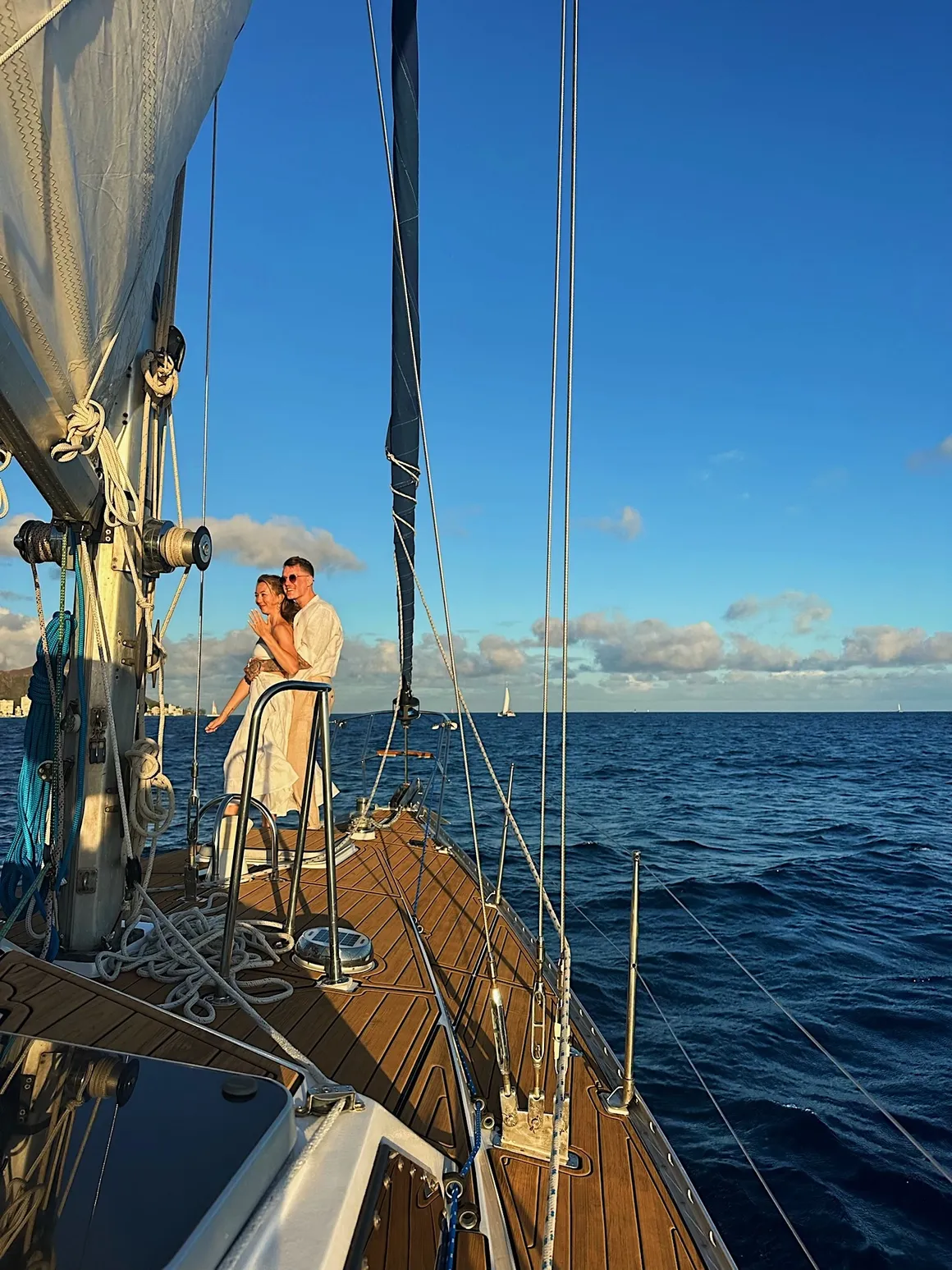 Couple hugging after a proposal aboard Sailing Beauty.